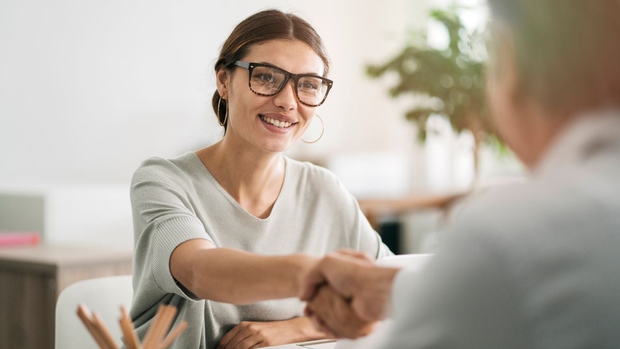woman shaking hands with man